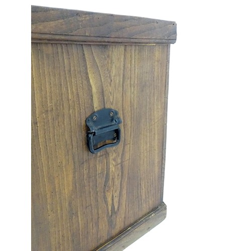 842 - An early to mid 20thC elm trunk with cast handles and paper lined interior. Approx 38