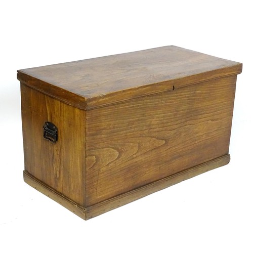 842 - An early to mid 20thC elm trunk with cast handles and paper lined interior. Approx 38