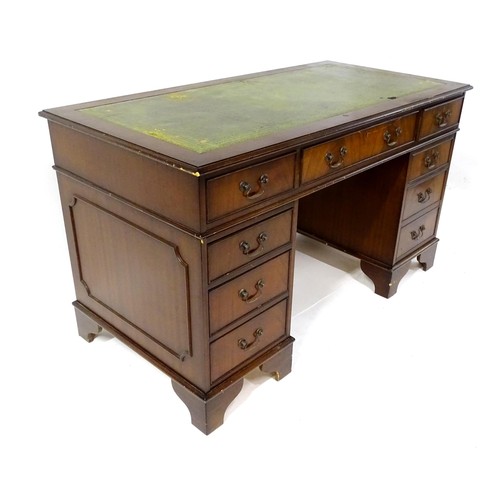 844 - A late 20thC mahogany pedestal desk, with green leather inset top and comprising three drawers over ... 