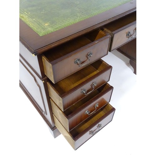 844 - A late 20thC mahogany pedestal desk, with green leather inset top and comprising three drawers over ... 