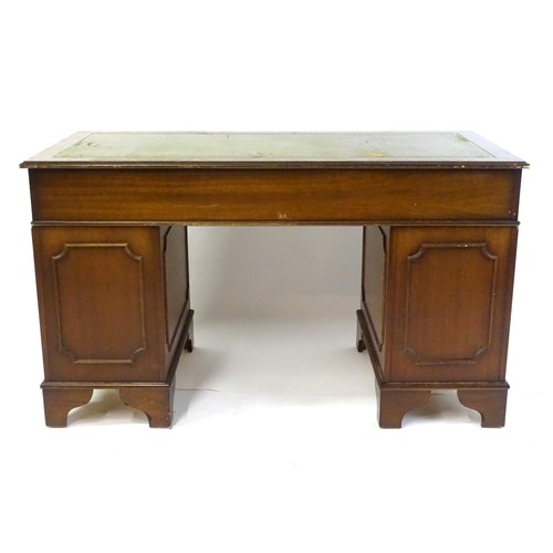 844 - A late 20thC mahogany pedestal desk, with green leather inset top and comprising three drawers over ... 