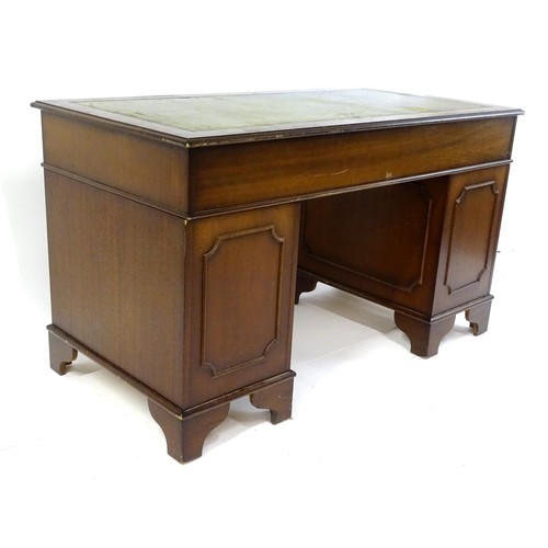 844 - A late 20thC mahogany pedestal desk, with green leather inset top and comprising three drawers over ... 