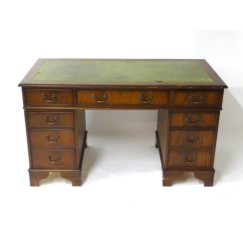 844 - A late 20thC mahogany pedestal desk, with green leather inset top and comprising three drawers over ... 