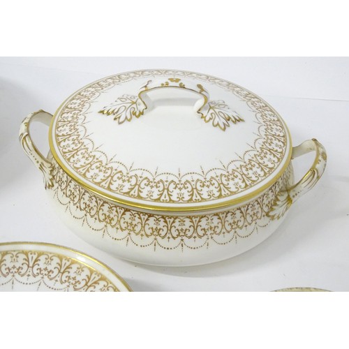 878 - A quantity of Crown Staffordshire dinner wares with gilt borders to include tureens, serving plates,... 