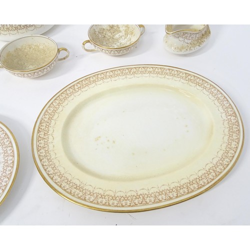 878 - A quantity of Crown Staffordshire dinner wares with gilt borders to include tureens, serving plates,... 