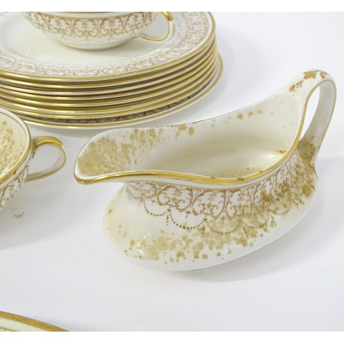 878 - A quantity of Crown Staffordshire dinner wares with gilt borders to include tureens, serving plates,... 