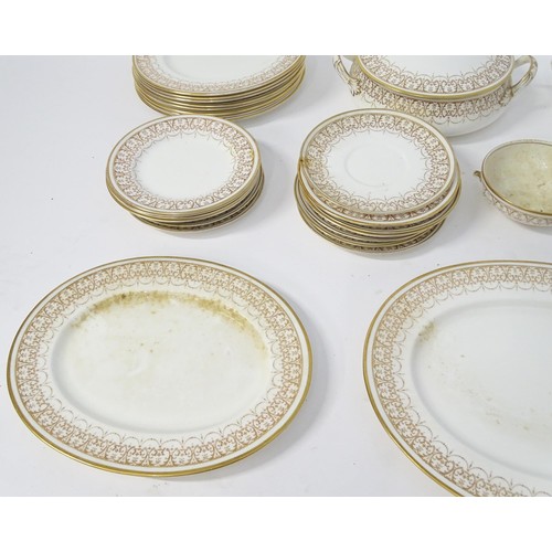 878 - A quantity of Crown Staffordshire dinner wares with gilt borders to include tureens, serving plates,... 