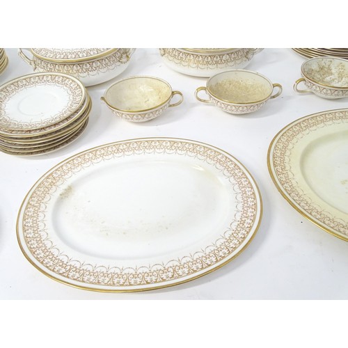 878 - A quantity of Crown Staffordshire dinner wares with gilt borders to include tureens, serving plates,... 