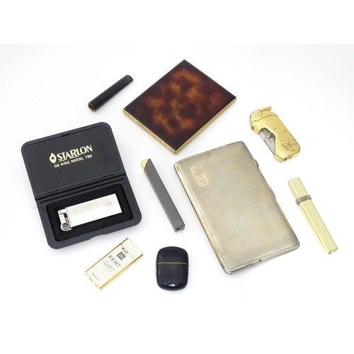 900 - A quantity of assorted smoking items, to include pocket lighters, cigarette cases and a cigarette ho... 