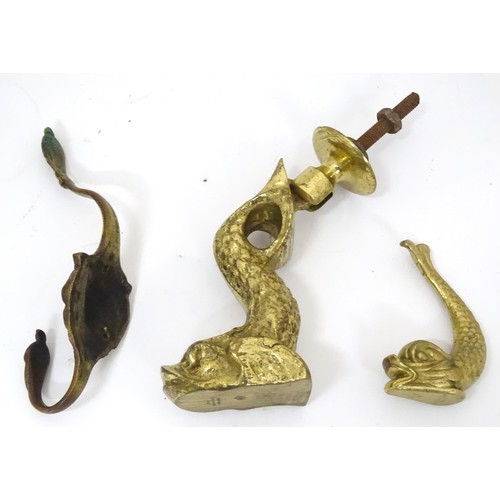 907 - A 20thC brass door knocker of fish form. Together with a coat hook with lion mask detail. Hook appro... 