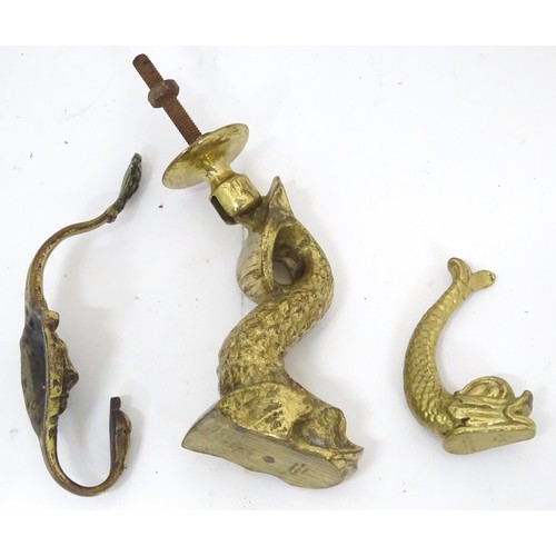 907 - A 20thC brass door knocker of fish form. Together with a coat hook with lion mask detail. Hook appro... 