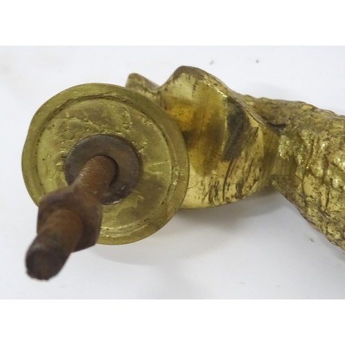 907 - A 20thC brass door knocker of fish form. Together with a coat hook with lion mask detail. Hook appro... 