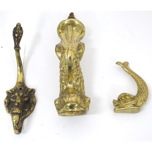 907 - A 20thC brass door knocker of fish form. Together with a coat hook with lion mask detail. Hook appro... 