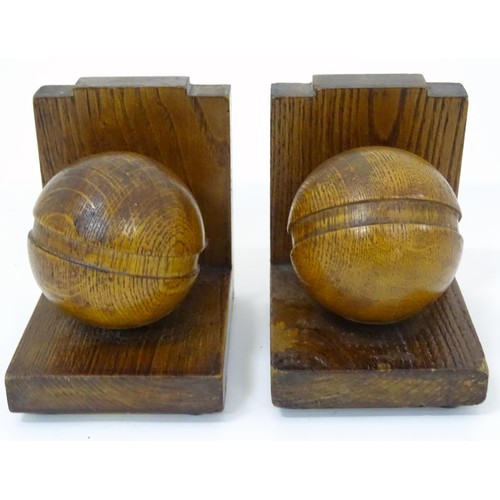 909 - A pair of c1930s oak bookends formed as cricket balls, each approx 4 1/2