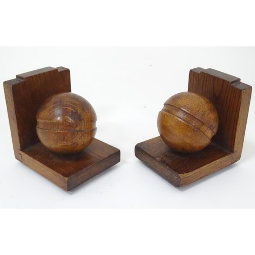 909 - A pair of c1930s oak bookends formed as cricket balls, each approx 4 1/2