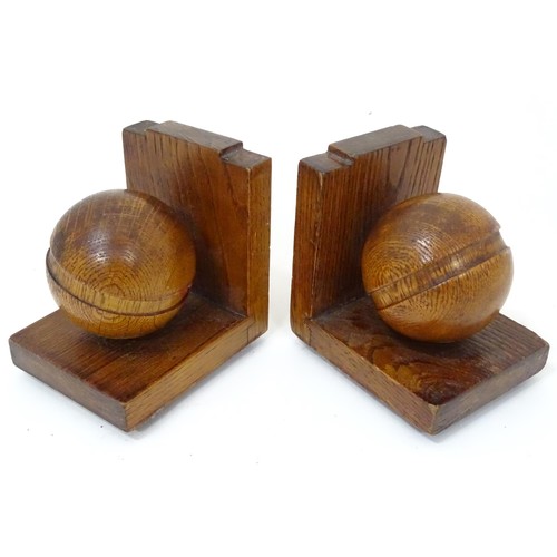 909 - A pair of c1930s oak bookends formed as cricket balls, each approx 4 1/2