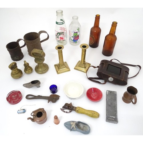 922 - A quantity of assorted items to include 
bull's head tin can openers, pictorial advertising milk bot... 