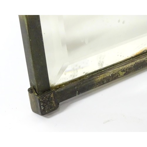 927 - A 20thC bevelled glass mirror, the brass frame decorated with urn and swag, approx 26 1/4