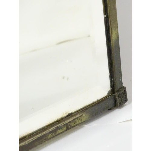 927 - A 20thC bevelled glass mirror, the brass frame decorated with urn and swag, approx 26 1/4