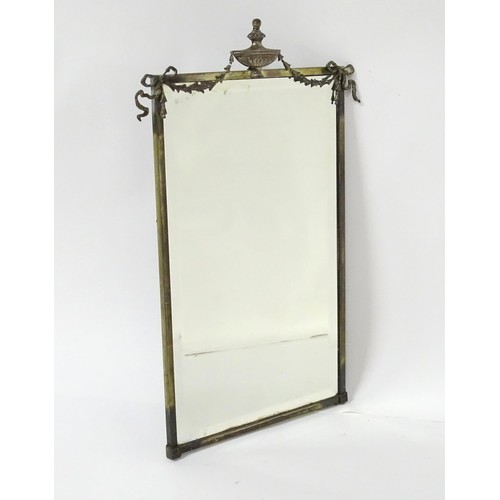 927 - A 20thC bevelled glass mirror, the brass frame decorated with urn and swag, approx 26 1/4