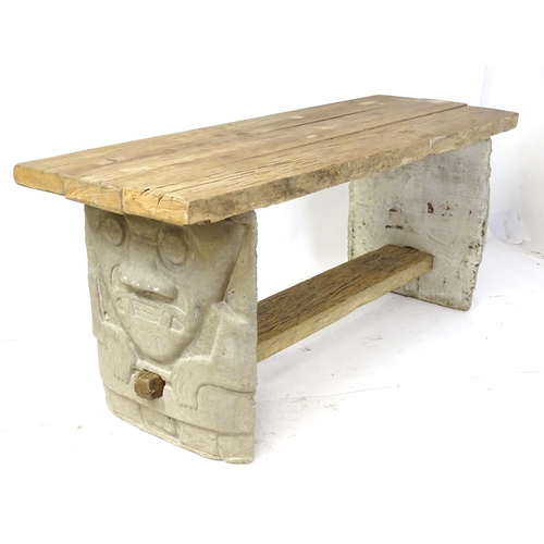 930 - An architectural garden table of substantial proportions, the uprights carved from stone and formed ... 