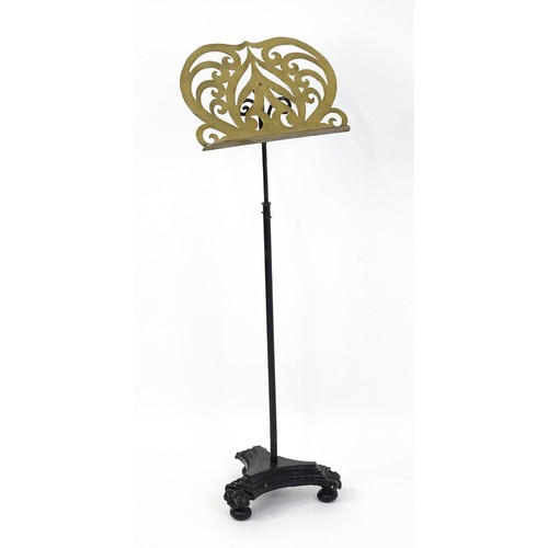 1578 - A Victorian music stand, the brass page rest formed as a lyre and supported by a painted wrought iro... 