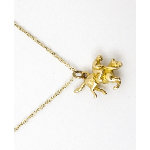 979 - A 9ct gold chain necklace set with 9ct gold pendant formed as a jockey on horse. Pendant approx. 5/8... 