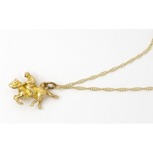 979 - A 9ct gold chain necklace set with 9ct gold pendant formed as a jockey on horse. Pendant approx. 5/8... 