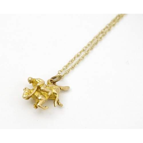 979 - A 9ct gold chain necklace set with 9ct gold pendant formed as a jockey on horse. Pendant approx. 5/8... 