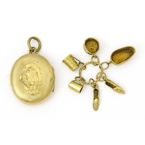 980 - A yellow metal locket with engraved decoration. Together with various yellow and gilt metal charms t... 