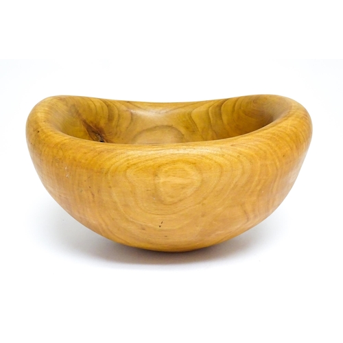 1409 - Treen : A 20thC carved wooden bowl oval form, stamped Caton under, possibly by Paul Caton. Approx. 1... 