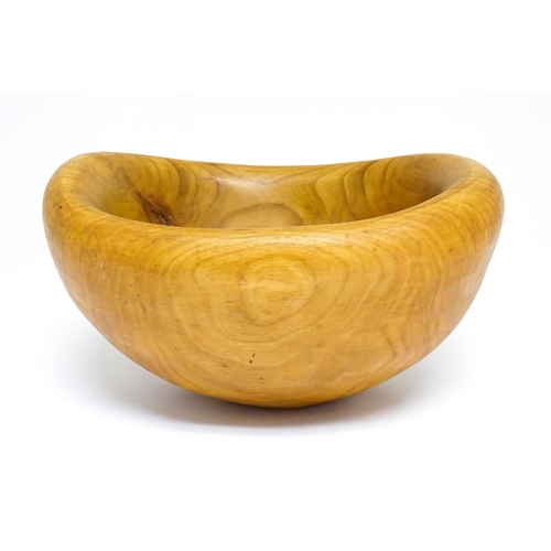 1409 - Treen : A 20thC carved wooden bowl oval form, stamped Caton under, possibly by Paul Caton. Approx. 1... 