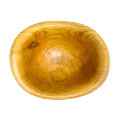 1409 - Treen : A 20thC carved wooden bowl oval form, stamped Caton under, possibly by Paul Caton. Approx. 1... 