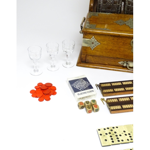 1532 - A Victorian oak tantalus / games compendium with silver plate mounts. With three glass decanters and... 