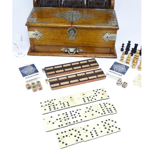 1532 - A Victorian oak tantalus / games compendium with silver plate mounts. With three glass decanters and... 