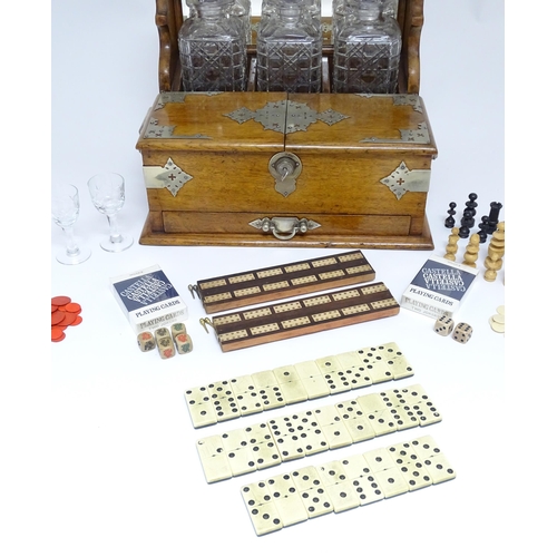 1532 - A Victorian oak tantalus / games compendium with silver plate mounts. With three glass decanters and... 