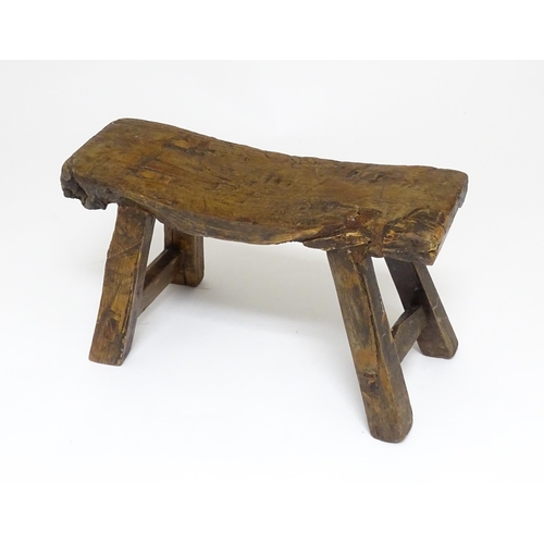 1739 - A 19thC oak country made small milking stool, the seat of rectangular form supported by four splayed... 