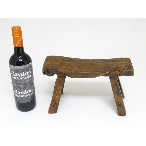 1739 - A 19thC oak country made small milking stool, the seat of rectangular form supported by four splayed... 