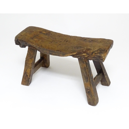 1739 - A 19thC oak country made small milking stool, the seat of rectangular form supported by four splayed... 