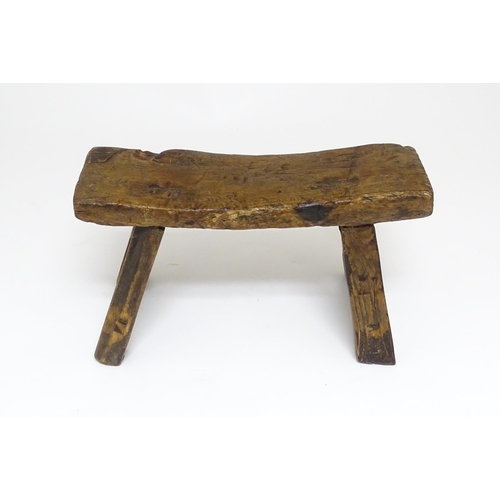 1739 - A 19thC oak country made small milking stool, the seat of rectangular form supported by four splayed... 