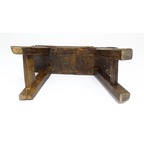 1739 - A 19thC oak country made small milking stool, the seat of rectangular form supported by four splayed... 