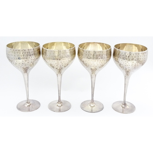 717 - Four late 20th / early 21stC silver plate goblets with hammered decoration. Approx. 8