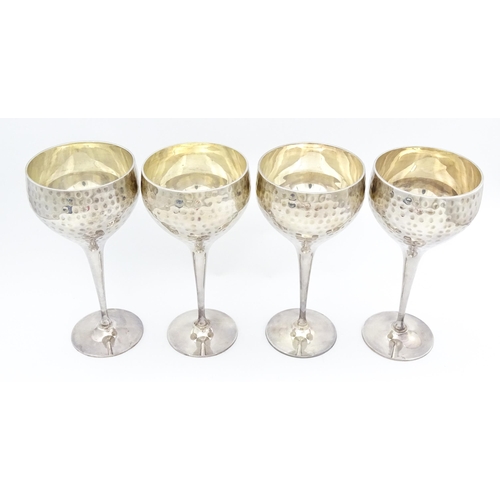 717 - Four late 20th / early 21stC silver plate goblets with hammered decoration. Approx. 8