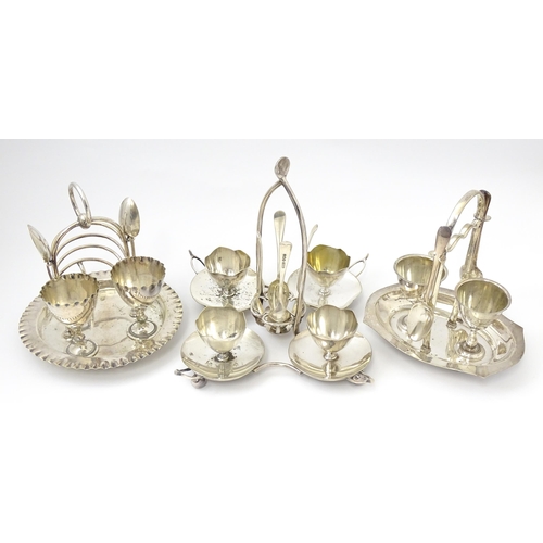 724 - Three assorted silver plate egg cruets, to include one with twin egg cups and toast rack section, an... 