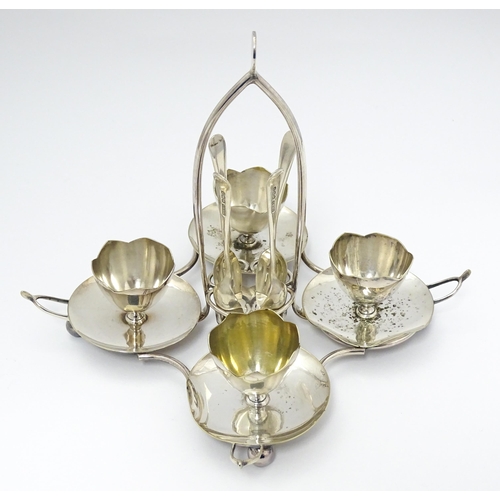 724 - Three assorted silver plate egg cruets, to include one with twin egg cups and toast rack section, an... 