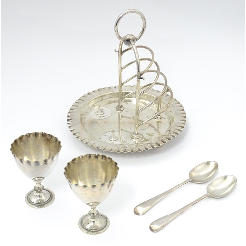 724 - Three assorted silver plate egg cruets, to include one with twin egg cups and toast rack section, an... 