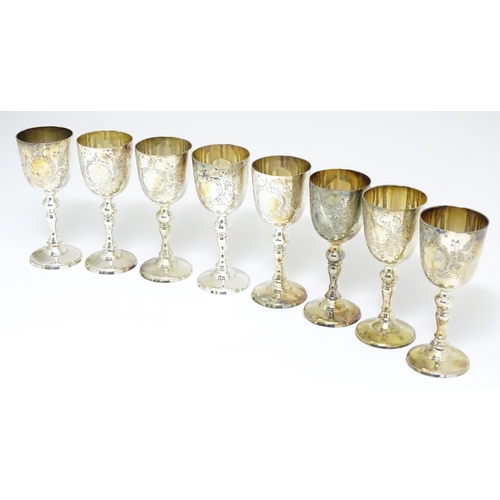 725 - A quantity of assorted silver plate items to include a set of eight goblets, tankard, chamberstick, ... 