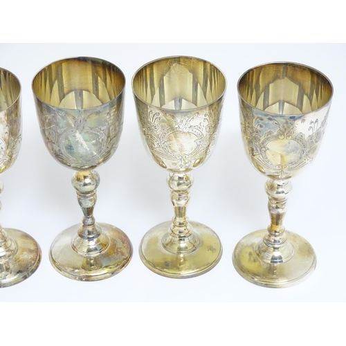 725 - A quantity of assorted silver plate items to include a set of eight goblets, tankard, chamberstick, ... 