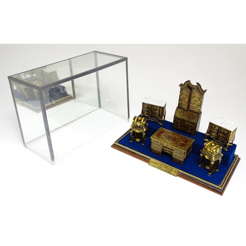 1497 - A showcase containing a display of early 21stC scale model miniature models of furniture to include ... 