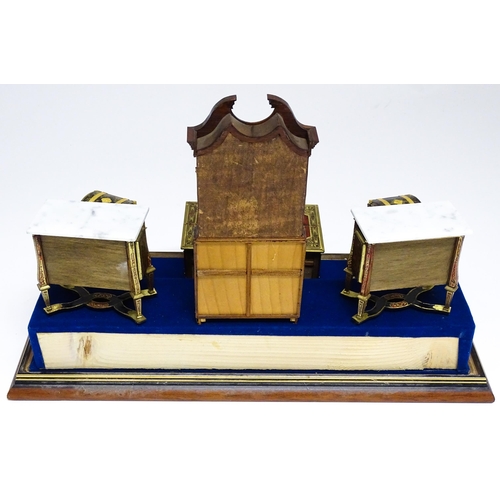 1497 - A showcase containing a display of early 21stC scale model miniature models of furniture to include ... 